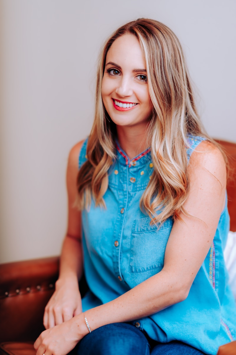 smiling girl in blue sleeveless dress